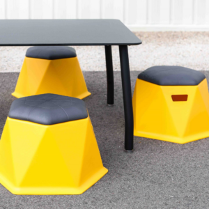 Yellow Twisted Hex Stools around a table outdoors