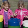 Children playing Rainbow Tuned Drums at park